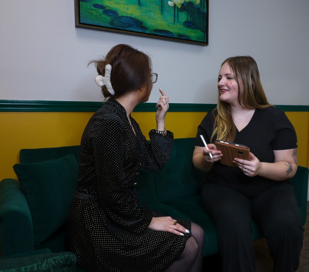 Owner of Ely-G luxury spa talking to a client, demonstrating personalized and attentive service, discussing customized beauty treatments and enhancing the client experience.