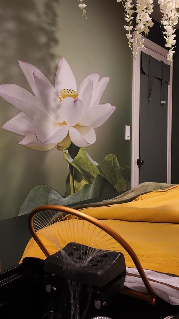 Asian head spa treatment bed with lotus mural and water basin at ELY-G Lashes & Spa in Bedford NH